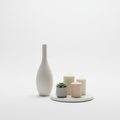 Minimalist home decor set with ceramic vase, marble tray and pillar candles on white background